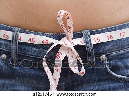 Stock Image - Measuring tape used as a belt. Fotosearch