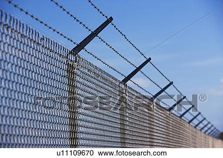 Metal fence with barbed wire View Large Photo Image Stock Image - Metal fence with barbed wire. Fotosearch