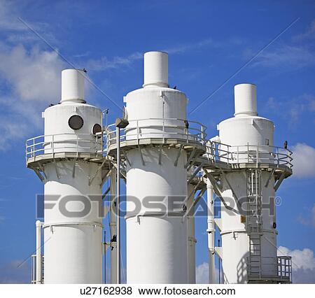 Metal silos under blue sky View Large Photo Image Stock Photo - Metal silos under blue sky. Fotosearch