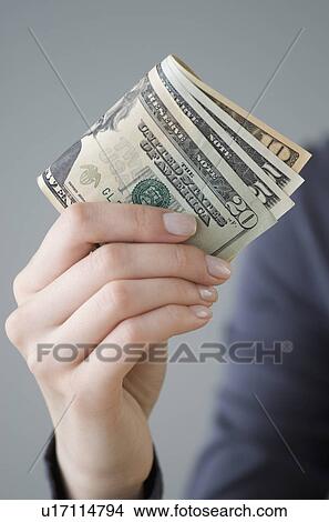 Picture - Money in woman’s hand. Fotosearch