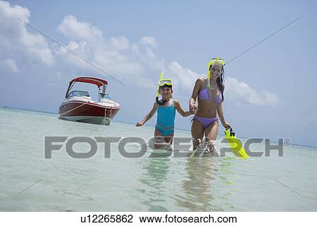 Mother and daughter with snorkeling gear walking in water, Florida, United States View Large Photo Image Stock Image - Mother and daughter with snorkeling gear walking in water, Florida, United States. Fotosearch