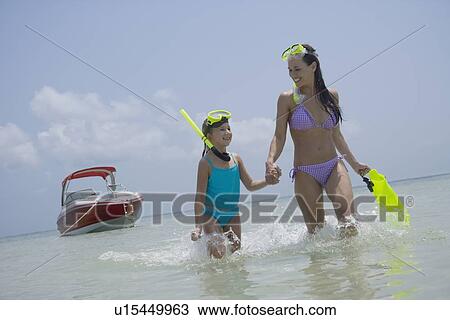 Mother and daughter with snorkeling gear walking in water, Florida, United States View Large Photo Image Stock Image - Mother and daughter with snorkeling gear walking in water, Florida, United States. Fotosearch