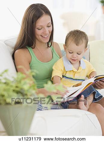 Stock Photo - Mother reading to baby. Fotosearch