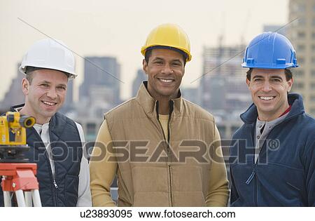 Stock Photography - Multi-ethnic male construction workers wearing hard hats. Fotosearch