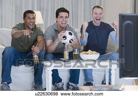 Multi-ethnic men watching sports on television View Large Photo Image Stock Photo - Multi-ethnic men watching sports on television. Fotosearch