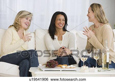 Stock Photograph - Multi-ethnic women laughing. Fotosearch