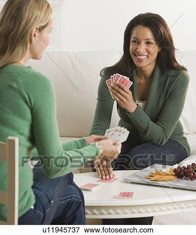 Stock Photo - Multi-ethnic women playing cards. Fotosearch