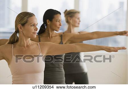 Picture - Multi-ethnic women practicing yoga. Fotosearch