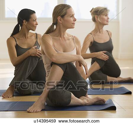 Multi-ethnic women practicing yoga View Large Photo Image Stock Photo - Multi-ethnic women practicing yoga. Fotosearch
