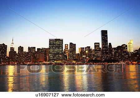 New York City skyline along water at night View Large Photo Image Stock Photo - New York City skyline along water at night. Fotosearch