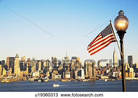 Stock Image - New York City skyline and American flag. Fotosearch