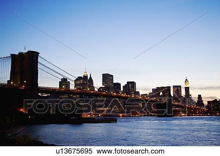 New York City skyline and Brooklyn Bridge at night View Large Photo Image Stock Photography - New York City skyline and Brooklyn Bridge at night. Fotosearch