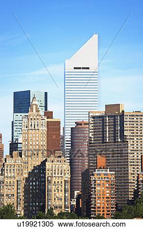Stock Photography - New York City skyline under blue sky. Fotosearch