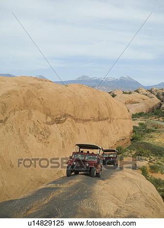 Off-road vehicles driving on rock formation View Large Photo Image Stock Photography - Off-road vehicles driving on rock formation. Fotosearch