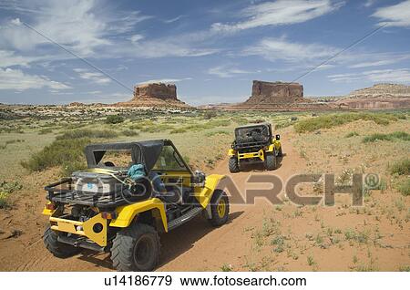 Off-road vehicles driving through desert View Large Photo Image Stock Photo - Off-road vehicles driving through desert. Fotosearch