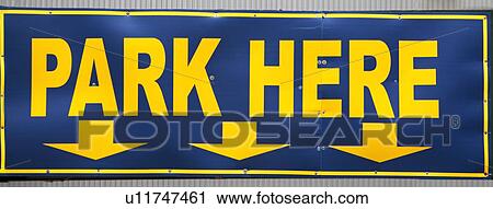 Stock Image - Park Here sign with arrows. Fotosearch