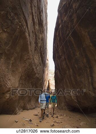 People hiking between rock formations View Large Photo Image Stock Photograph - People hiking between rock formations. Fotosearch