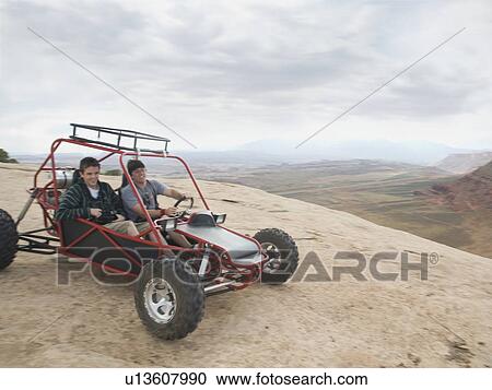 People in off-road vehicle on rock formation View Large Photo Image Stock Image - People in off-road vehicle on rock formation. Fotosearch