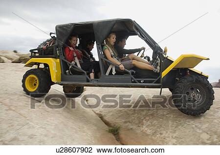 People in off-road vehicle on rock formation View Large Photo Image Stock Image - People in off-road vehicle on rock formation. Fotosearch