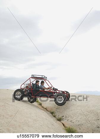 People in off-road vehicle on rock formation View Large Photo Image Stock Photo - People in off-road vehicle on rock formation. Fotosearch