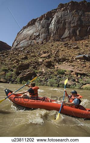 Stock Image - People paddling in raft. Fotosearch