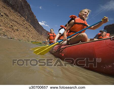 Stock Photo - People paddling in raft. Fotosearch