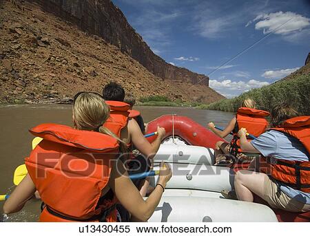 Stock Photography - People paddling in raft. Fotosearch