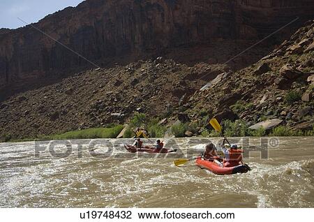 Stock Image - People paddling in rafts. Fotosearch