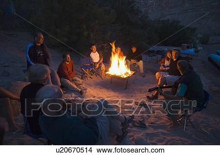People relaxing around camp fire View Large Photo Image Picture - People relaxing around camp fire. Fotosearch