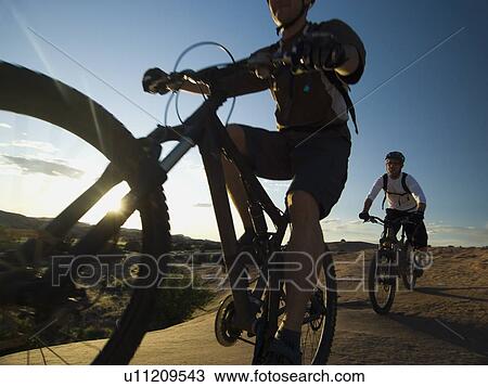 People riding mountain bikes View Large Photo Image Stock Image - People riding mountain bikes. Fotosearch