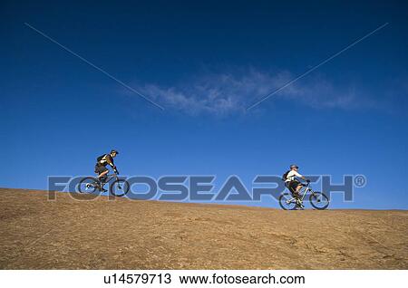 People riding mountain bikes View Large Photo Image Stock Image - People riding mountain bikes. Fotosearch