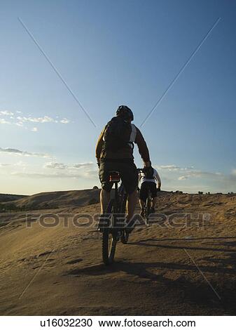 Stock Image - People riding mountain bikes. Fotosearch