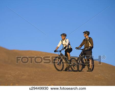 People riding mountain bikes View Large Photo Image Stock Image - People riding mountain bikes. Fotosearch