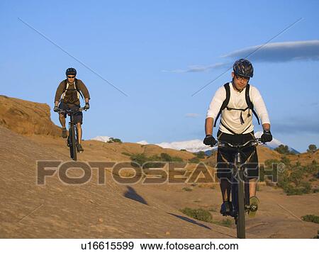 Stock Photo - People riding mountain bikes. Fotosearch