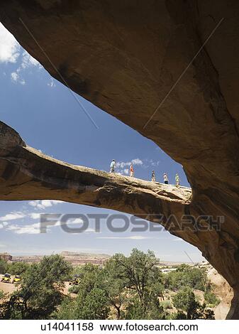 Stock Photo - People walking on rock formation. Fotosearch