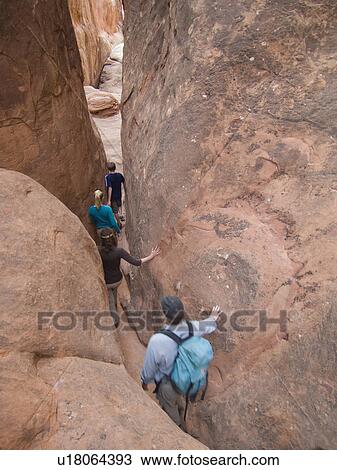 People walking through rock formations View Large Photo Image Stock Image - People walking through rock formations. Fotosearch
