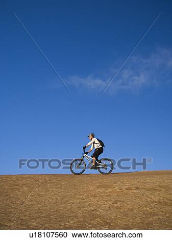 Person riding mountain bikes View Large Photo Image Stock Image - Person riding mountain bikes. Fotosearch