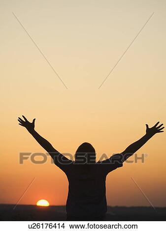 Picture - Person with arms raised. Fotosearch