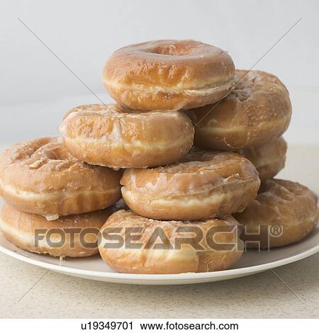 Pile of glazed donuts on plate View Large Photo Image Stock Image - Pile of glazed donuts on plate. Fotosearch