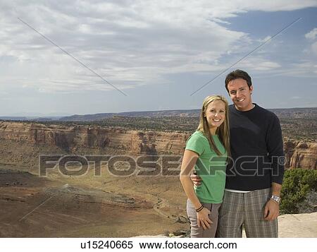 Stock Photography - Portrait of couple in front of canyon. Fotosearch
