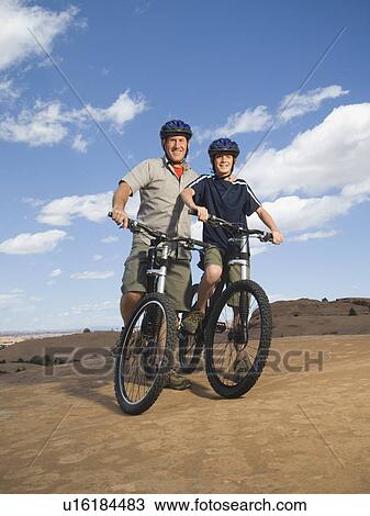 Portrait of father and son on mountain bikes View Large Photo Image Stock Image - Portrait of father and son on mountain bikes. Fotosearch