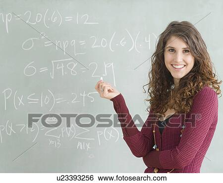 Portrait of female student in front of blackboard View Large Photo Image Stock Photograph - Portrait of female student in front of blackboard. Fotosearch