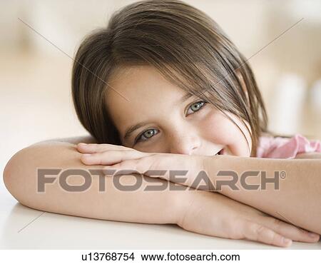 Picture - Portrait of girl leaning head on arms. Fotosearch