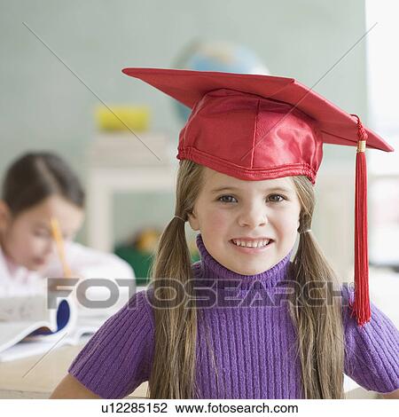 Stock Image - Portrait of girl wearing graduation cap. Fotosearch