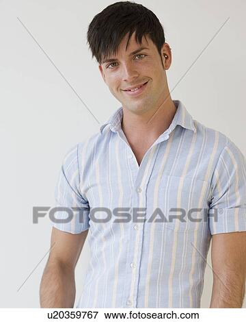 Stock Photo - Portrait of man wearing button down shirt. Fotosearch