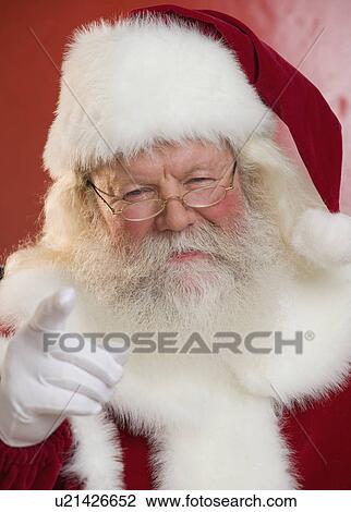 Stock Image - Portrait of Santa Claus pointing. Fotosearch