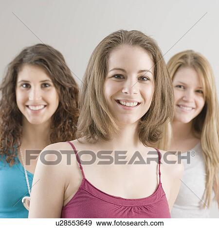 Portrait of teenage girl with friends in background View Large Photo Image Stock Photo - Portrait of teenage girl with friends in background. Fotosearch