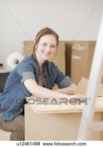 Stock Photo - Portrait of woman in new house. Fotosearch