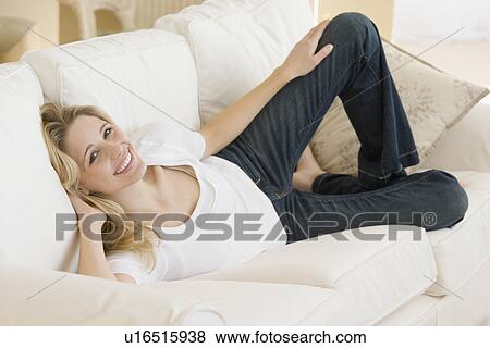 Portrait of woman laying on sofa View Large Photo Image Stock Photo - Portrait of woman laying on sofa. Fotosearch