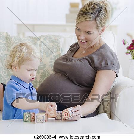 Picture - Pregnant mother playing with toddler. Fotosearch